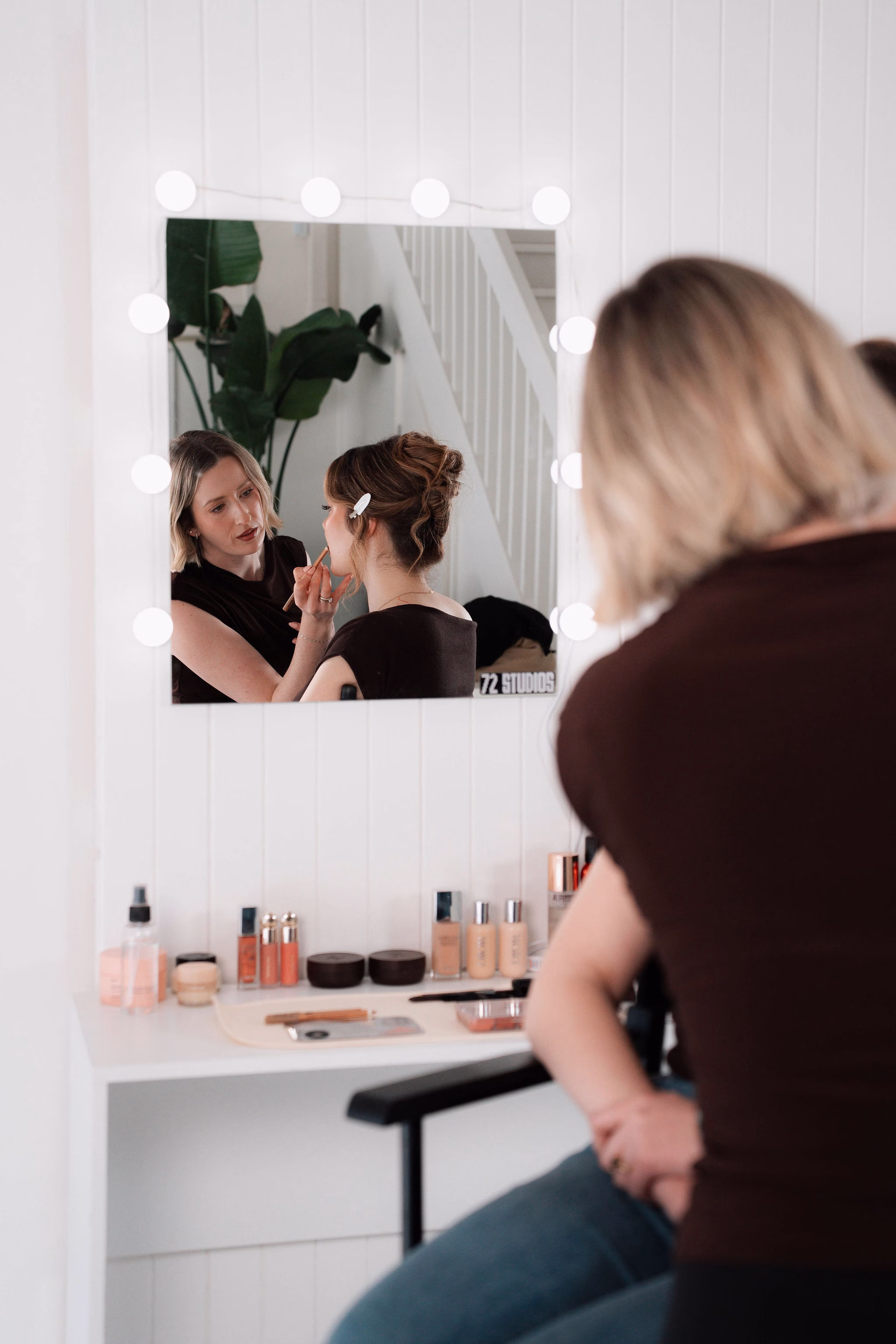 Makeup being applied to a client before an event