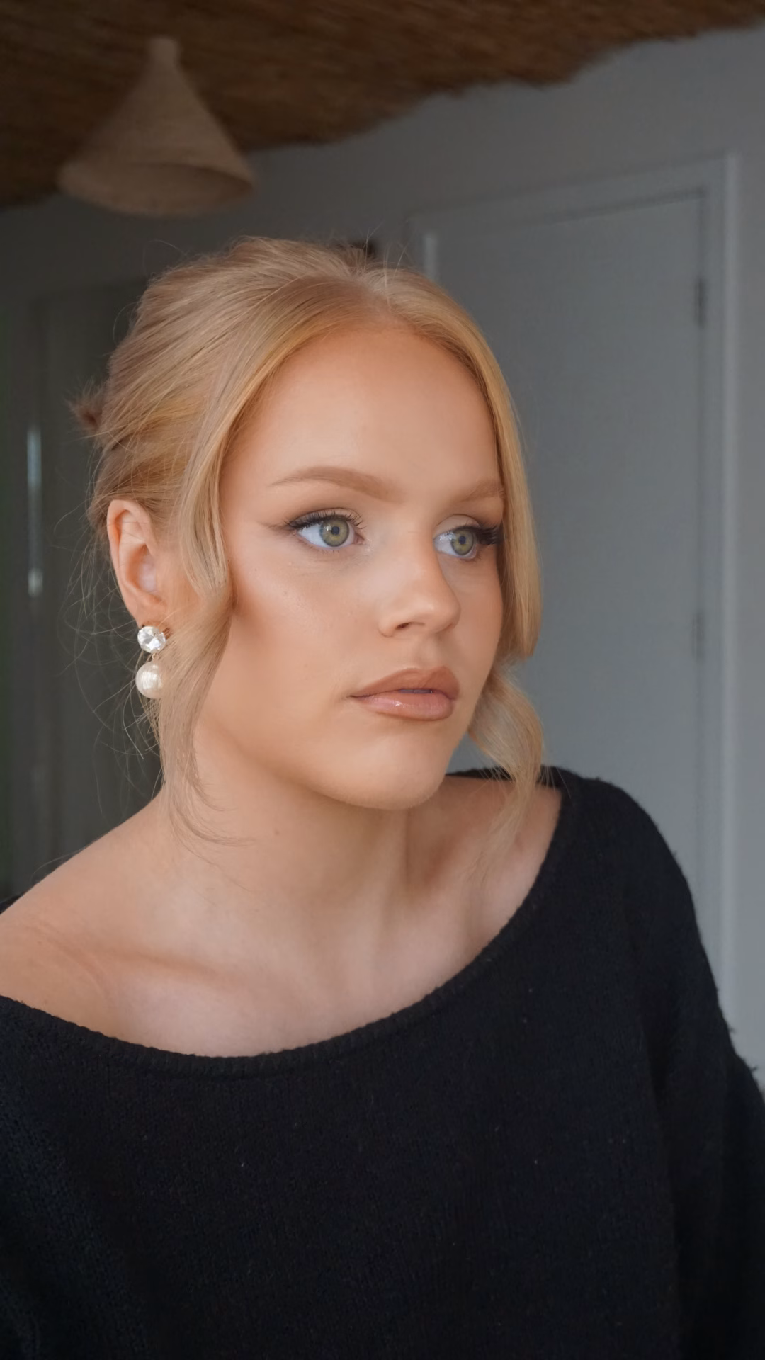 Close-up of soft glam makeup with winged liner and a glossy lip