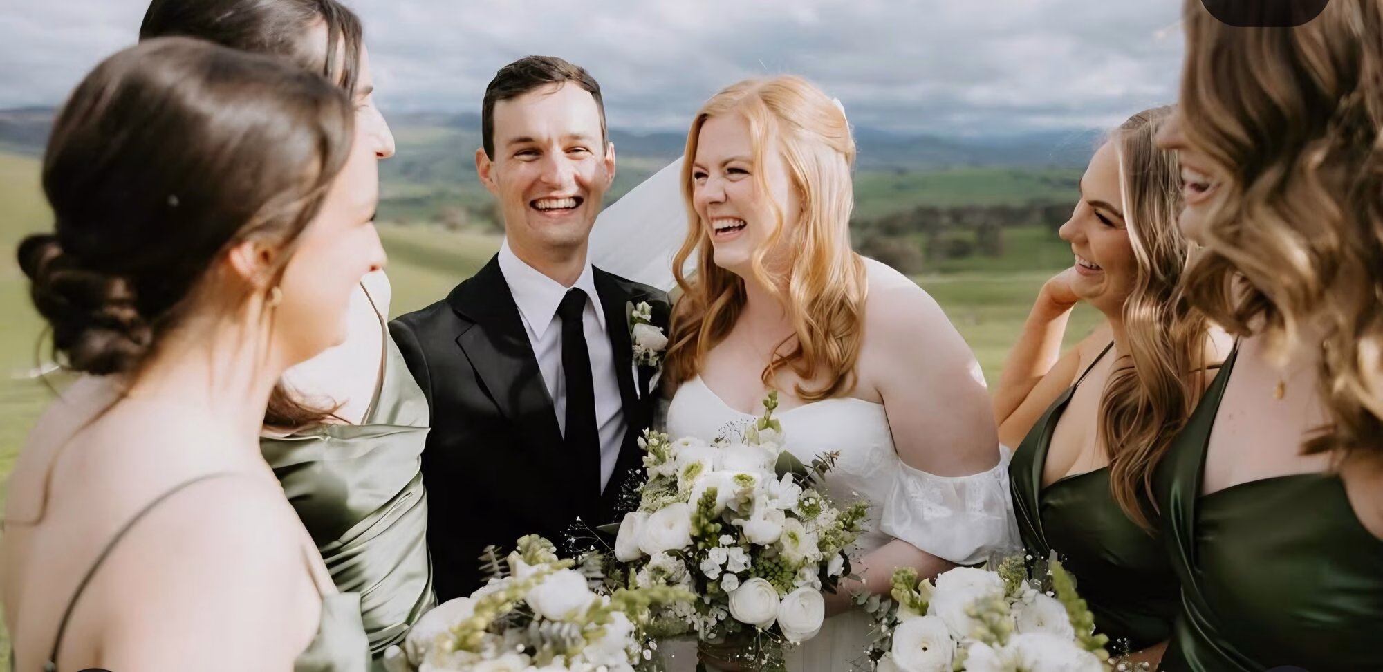 Groom laughing with the bridal party